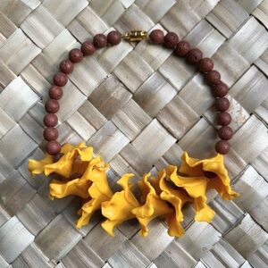 Burnt yellow hibiscus with lava beads car lei